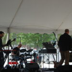 BASE band plays under a white tent.