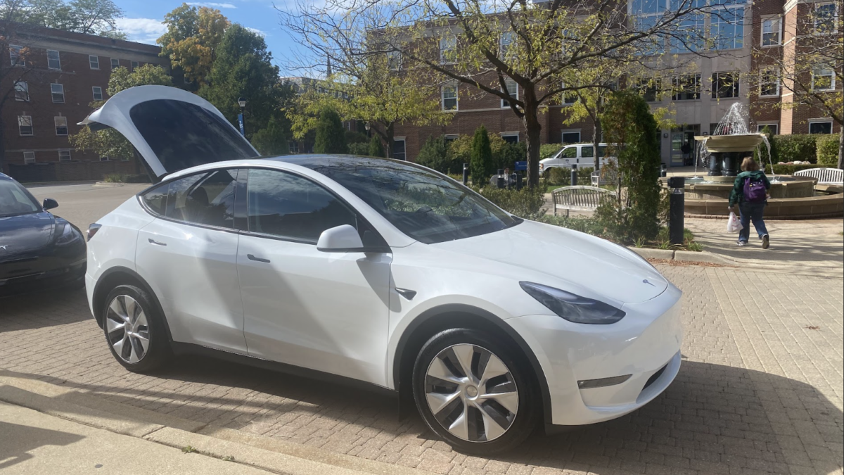A Tesla vehicle is parked in front of the A.C. Buehler Library